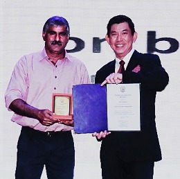 Mr. Gobinathan (D.N.S.) receiving the memento from Mr. Steven Chan